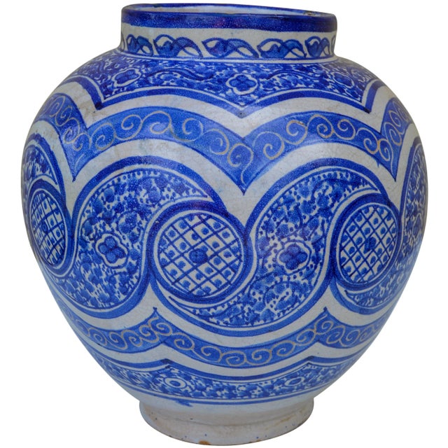 Antique handcrafted and glazed ceramic vase. Features an intricately hand-painted Moorish pattern in blue and white with...
