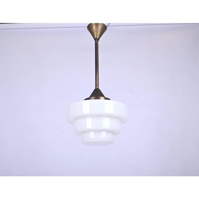 Art Deco Cascade Pendant Light in Brass and Opaline Glass, 1930s, in Very Good conditions. Designed 1920 to 1949 Up to...