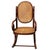 Turn of the century Vienna Secession oak child size rocking chair features an elegant, sculptural frame crafted from warm-...