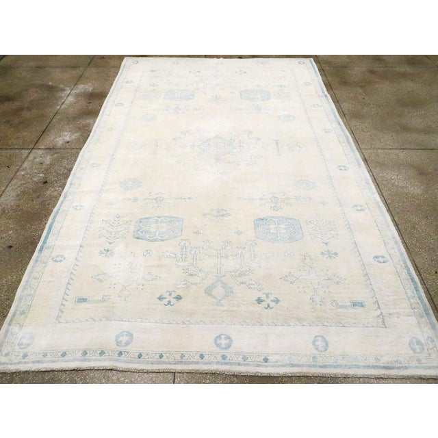 A Vintage Indian Cotton Agra Carpet handmade during the Mid-20th century. Measures: 7' 10" x 12' 8"
