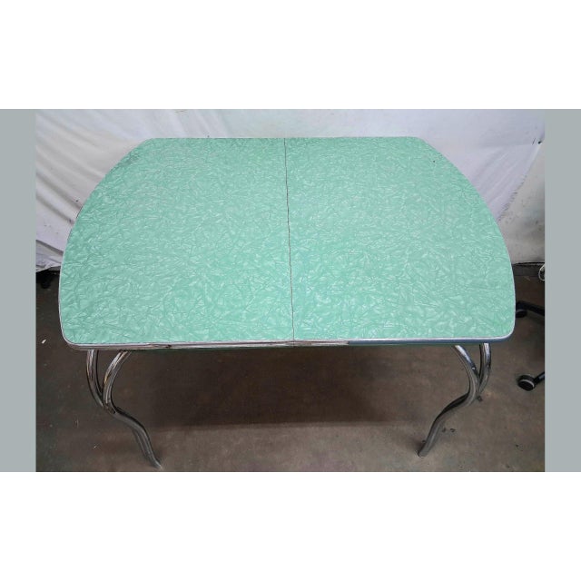 An iconic post-war American dining table by Virtue Brothers of Los Angeles. The piece features a durable, speckled green...