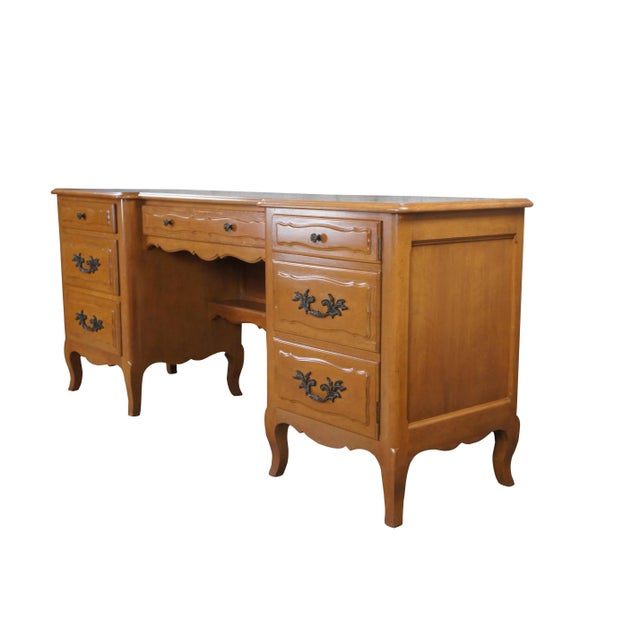 Mid century French Provincial vanity desk or credenza featuring serpentine form with antiqued mirrored top, four drawers...