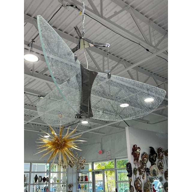 Large, spectacular suspension light designed by the Glass Masters at Leucos Lighting in Murano. Crackled glass is lighted...