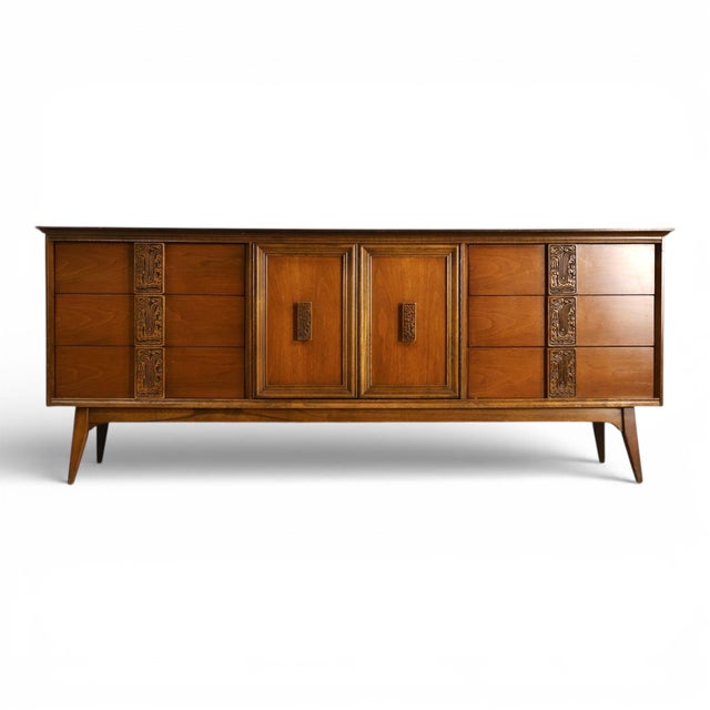 This 1960s Bassett Mayan lowboy dresser is a distinctive example of American Mid Century Modern design, combining clean-...