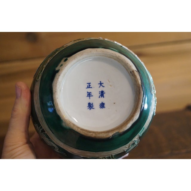 A pair of beautifully glazed Chinese pots which are decorated with birds and flora. These pots are marked on their bottoms...