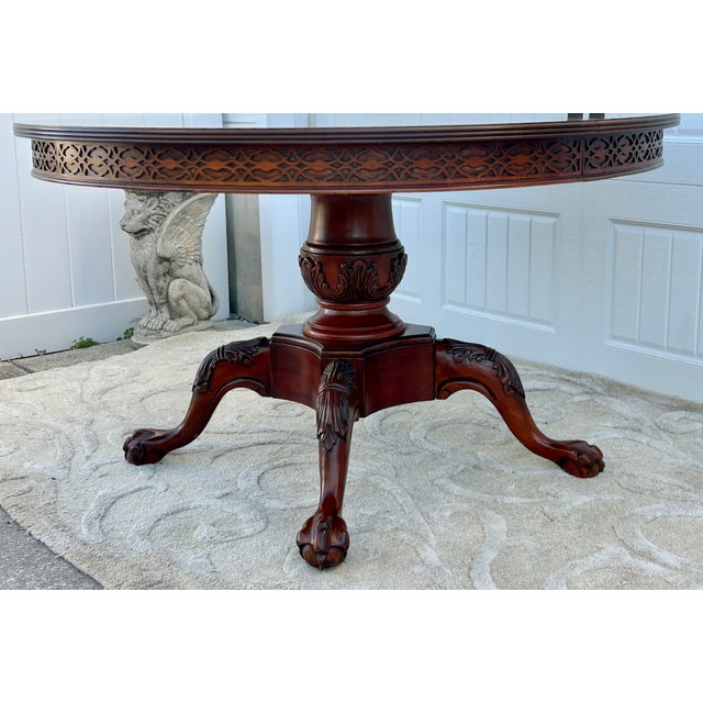 Vintage (1990's) Round Dining Table (no name found) with a Pedestal Base. Made of Wood. Carved Mahogany with Banded Inlay....