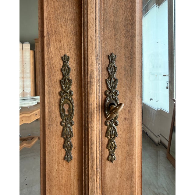 Large two-door louis xvi style mirrored wardrobe, dating from the late 19th or early 20th century. Its gadrooned cornice,...