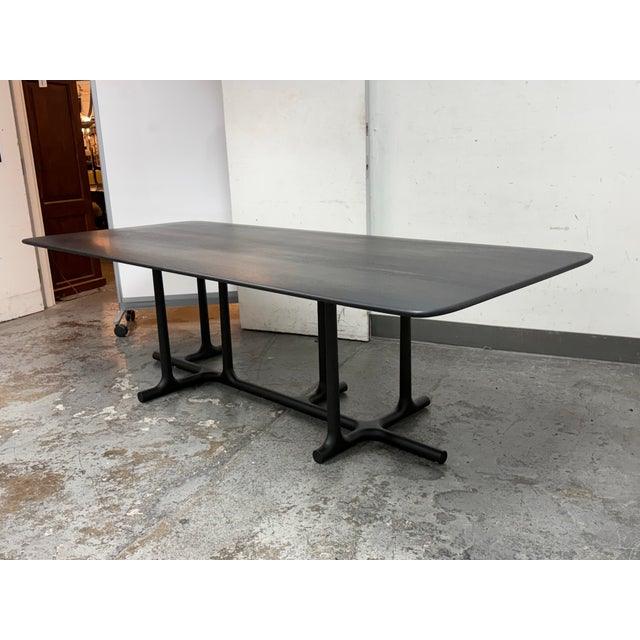 Design Plus Gallery presents the Tye Dining Table by Christophe Decourt. The perpendicular asymmetry of the leg design...