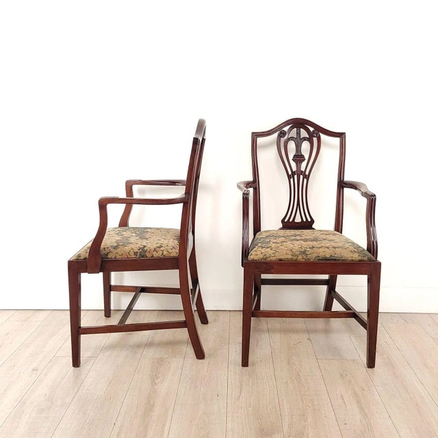A pair of Hepplewhite armchairs, England, 19th century. Seat height 19.75".
