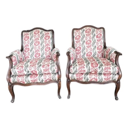 Louis XV–Style Walnut Bergère Armchairs in Ikat Upholstery With Brass Nail Head Trim — 20th Century Matching Pair For Sale