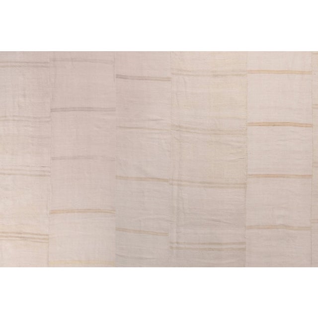 Hand woven in wool originating from Turkey between 1970-1980, this vintage paneled kilim rug enjoys a play of subtle beige...