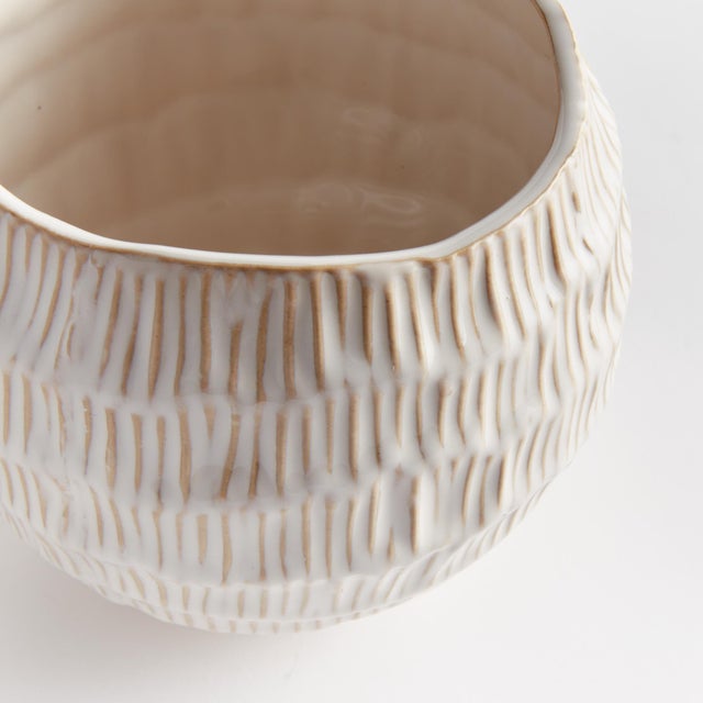 With a rounded form and unique hatched pattern, this sweet little pot has an artisans touch. Finished In a reactive glaze,...