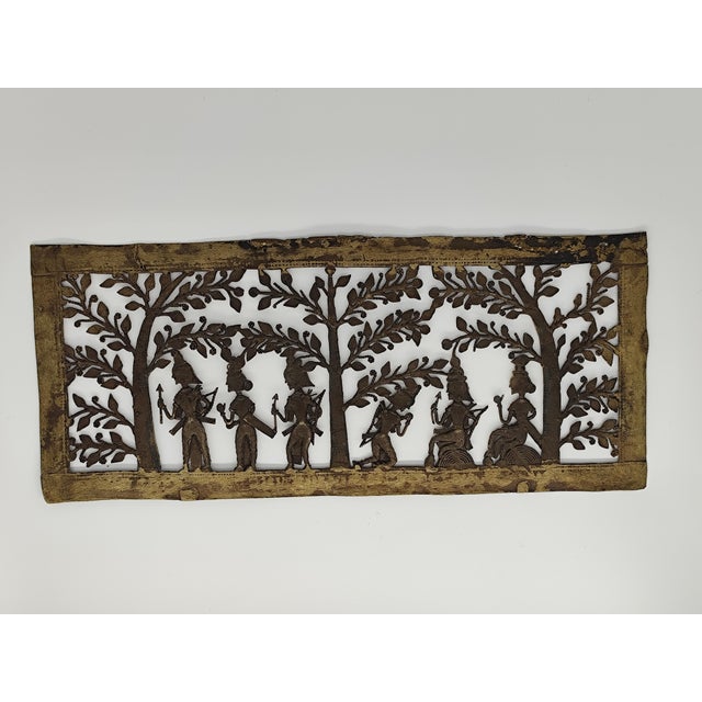 This decorative panel is an example of Dhokra art, a traditional bell-shaped metal casting technique from India, often...