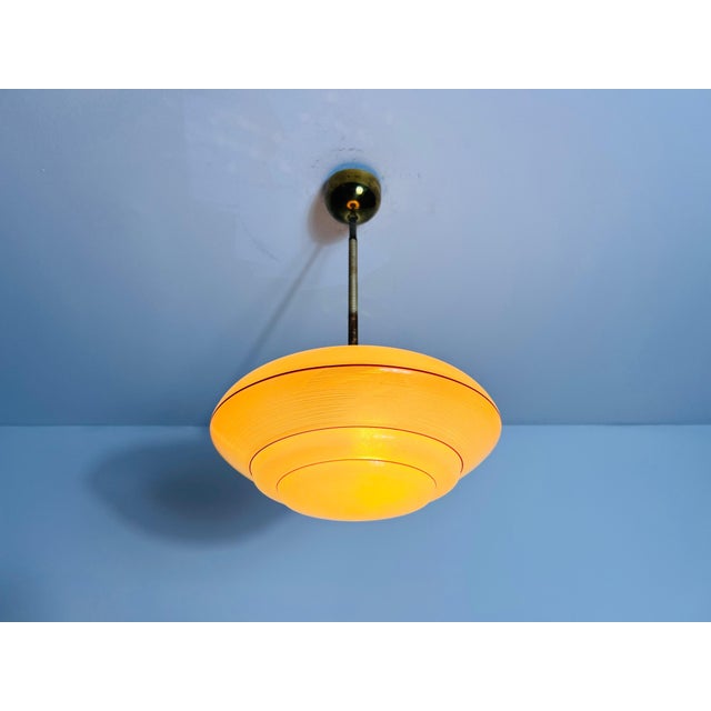 Beautiful glass pendant lamp from the 1930s, made in Germany. The soft, diffused light passing through the veined glass...