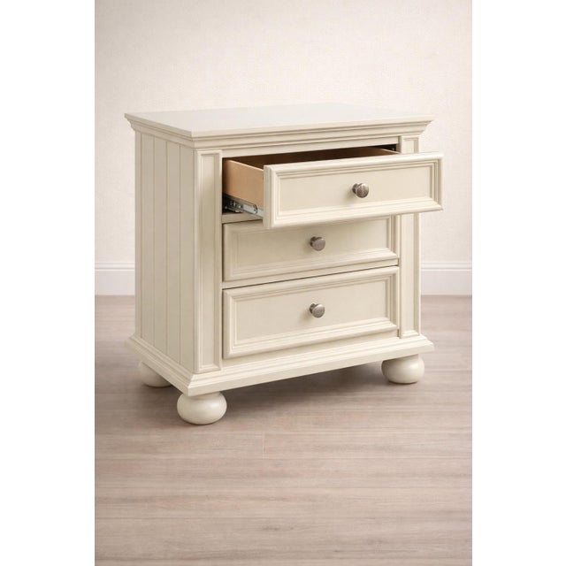 Charming vintage three-drawer nightstand freshly painted in a soft antique white. Solid, well-built construction with...