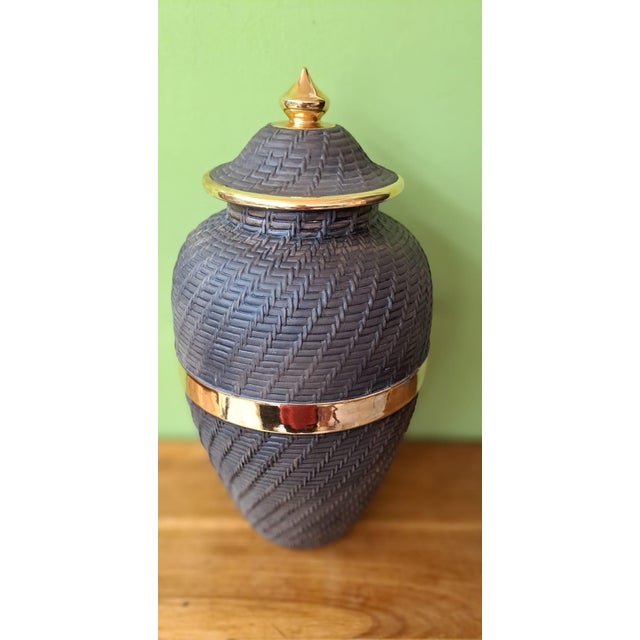 Ceramic jar with an intricately textured relief resembling traditional braiding, reminiscent of basketry, elegantly...