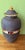 Ceramic jar with an intricately textured relief resembling traditional braiding, reminiscent of basketry, elegantly...