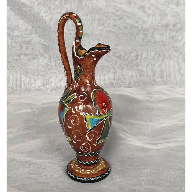 Formed into the shape of an ancient oinochoe single-handled jug, this miniature Deruta Fidas Italian pottery vase is hand-...