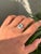 This art deco target ring features a 0.18 carat octagon cut emerald set in 14K white gold. The emerald measuring...
