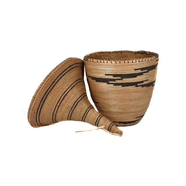 The Tutsi Tight Weave Basket with Lid from Rwanda epitomizes the artistry and tradition of the Tutsi community's weaving...