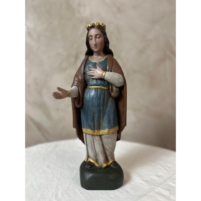 A polychrome carved wooden religious sculpture dating from the early 19th century, depicting the Virgin Mary in a gentle...