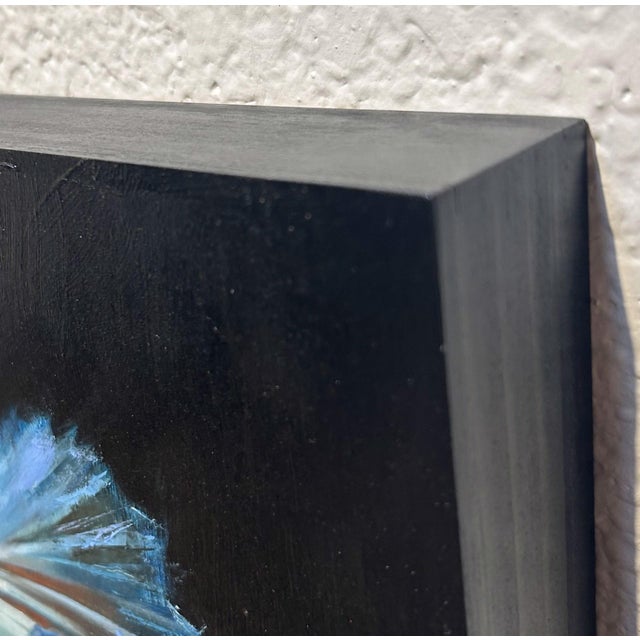 This oil painting captures the graceful motion of a Betta fish, its flowing fins rendered in vibrant hues of blue, yellow,...