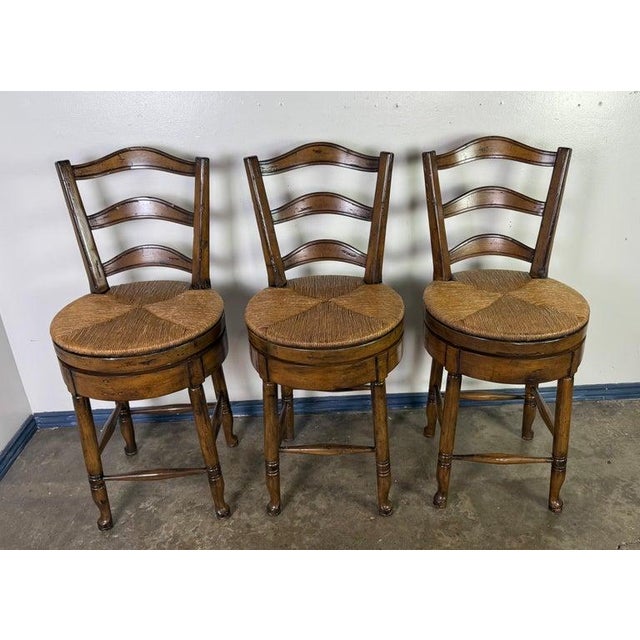 Set of Three French Provincial Style Ladder-Back Bar Stools with Rush Seats France, Mid-20th Century A charming set of...