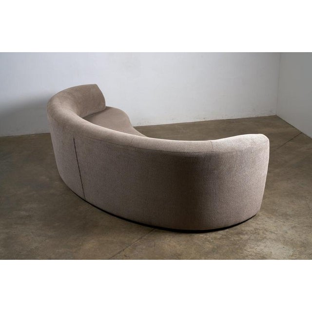 Elegant curved sofa has a distinct crescent or "kidney bean" shape that invites conversation and adds a seamless flow to...