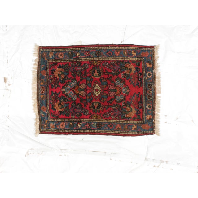 An antique wool pile handmade Persian Malayer rug. The rug is in excellent condition. It features a red back ground with...
