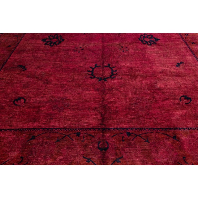Beautiful Transitional style hand-knotted wool rug with a red field. This piece has dark accents, featuring a gorgeous...