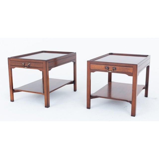 Pair of Regency style mahogany end tables Circa 1920 Each of the tables are raised upon chamfered legs with an undertray...