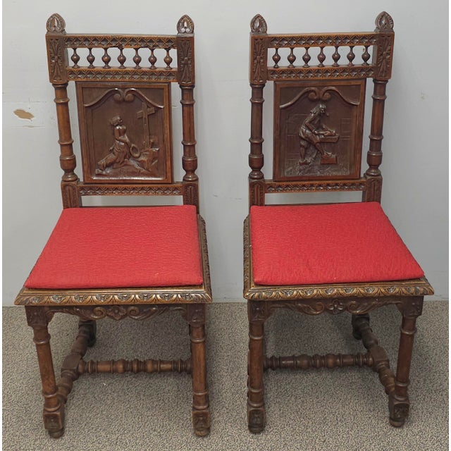 A Pair Jacobean Style Carved Oak and Caned Seat Side Chairs with red cushions Measures 17.5" in with, 17.5" in depth and...