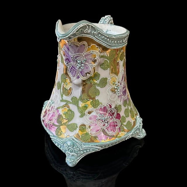 An antique Japanese Nippon porcelain tankard. Unsigned. The age is estimated to be ca 1900. Floral motif with extensive...