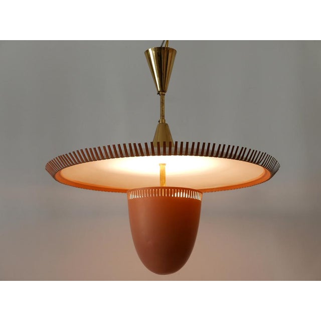Extremely rare, lovely and highly decorative mid-century modern two-flamed pendant lamp or chandelier. Designed and...