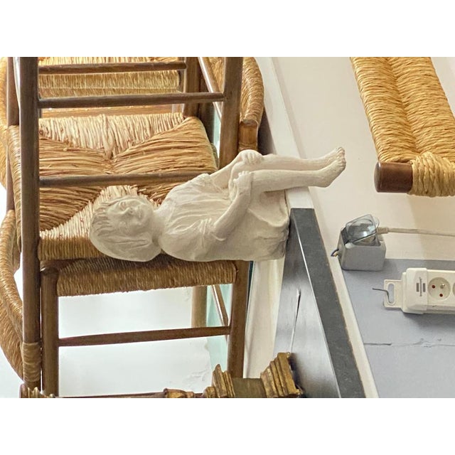 This Sitting woman is in Plaster. It is an Art Deco sculpture, made circa 1930, in France. In a white color. In the Style...