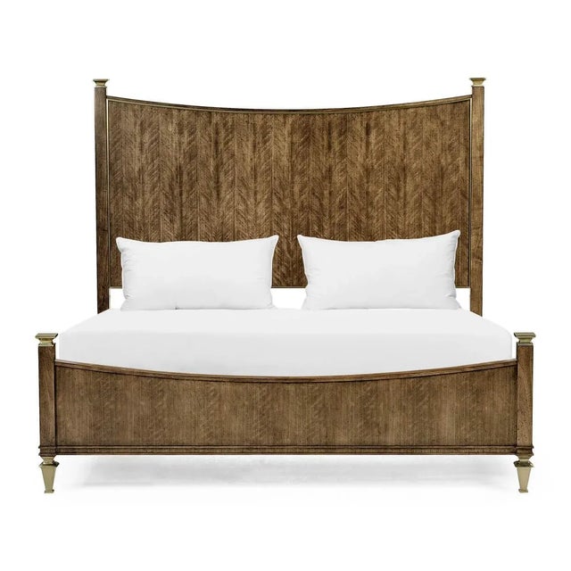A European classic figured quartered walnut king-size bed, with a sloped headboard and footboard and a with molded edges...