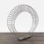 This modern metal sculpture features a circular wire design with an open center. The structure is made from sturdy metal...