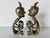 Striking pair of vintage African tribal bronze sculptures, each depicting a stylized nude figure in a seated,...