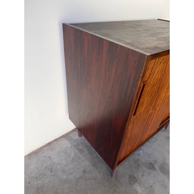 This elegant vintage Danish rosewood cabinet is a beautiful example of Scandinavian design, combining rich material with...