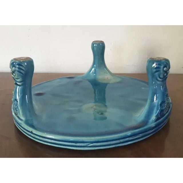 Antique 19th century Chinese porcelain stand or plateau in a bright peacock blue monochrome glaze. Rising on three...