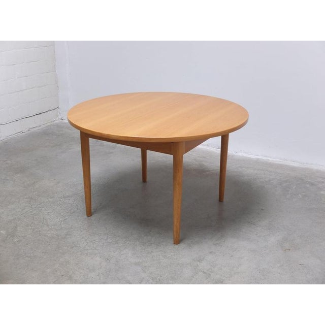 Beautiful dining table produced by Van Den Berghe-Pauvers around 1970. The round top is extendable and made of oak with a...