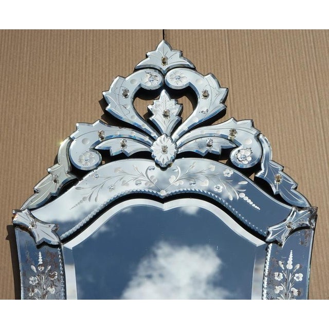 A beautiful antique Italian Venetian wall mirror, circa 1910, with an elegant heart-shaped form and richly decorative...