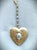 Beautiful Vintage heart-shaped paisley-embossed large gold locket with a grey oval pearl in a beautiful gold scalloped...