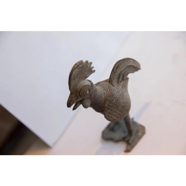 :: Vintage handmade African lightly oxidized rooster sculpture. Circa late mid 20th century, each figure in this...