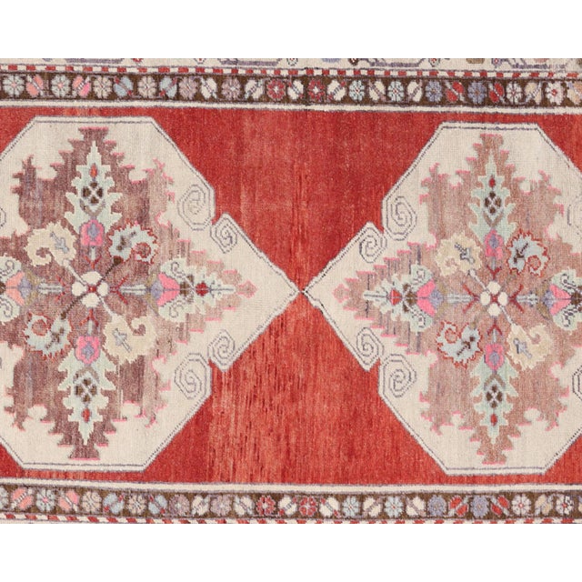 Handwoven vintage Turkish Oushak runner measuring 3'5" x 10'8". Crafted with wool on wool foundation in Western Turkey's...
