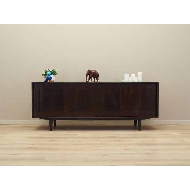 The sideboard was made in the 1970s, Danish production. The structure is covered with oak veneer. The legs are made of...