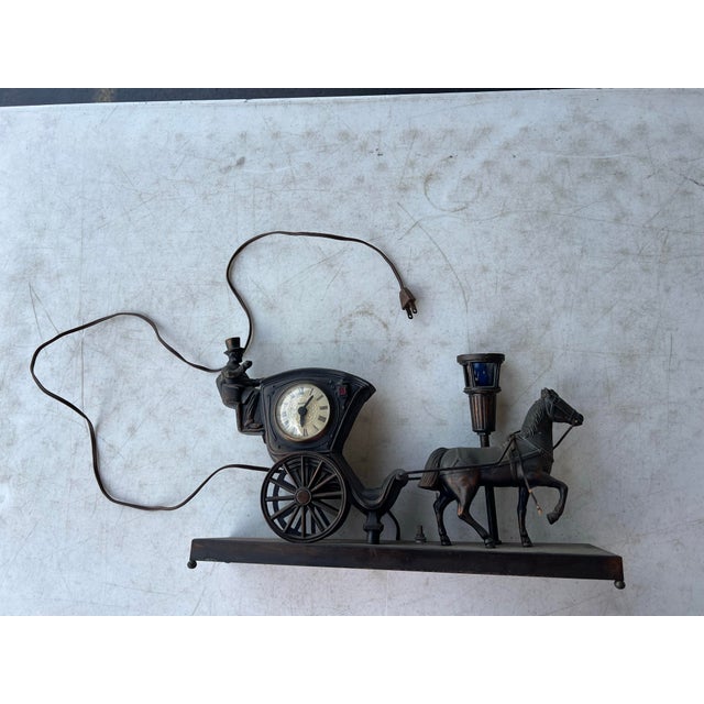Mid Century Horse Carriage Clock & Lamp marked United Metal Goods. Rare bar light works. Measures 16” x 4” and 10” tall.