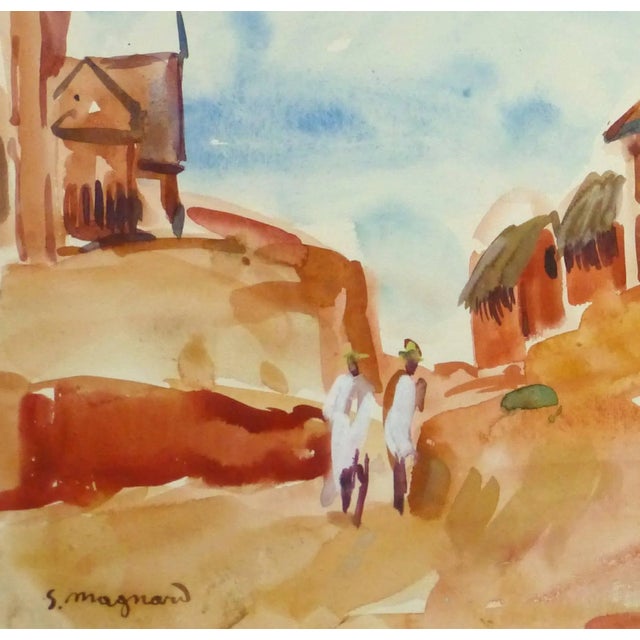 Vivid and bright watercolor landscape of a village perched atop a hillside in Madagascar by French artist Stephane Magnard...