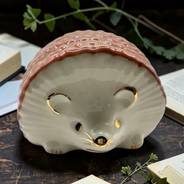 Add a touch of vintage European charm to your home decor or collection with this beautiful, mid-century porcelain hedgehog...
