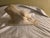 Vincent Glinsky The Awakening stone composite sculpture measuring 7 x 11.5 x 3 inches, featuring a reclining nude woman in...